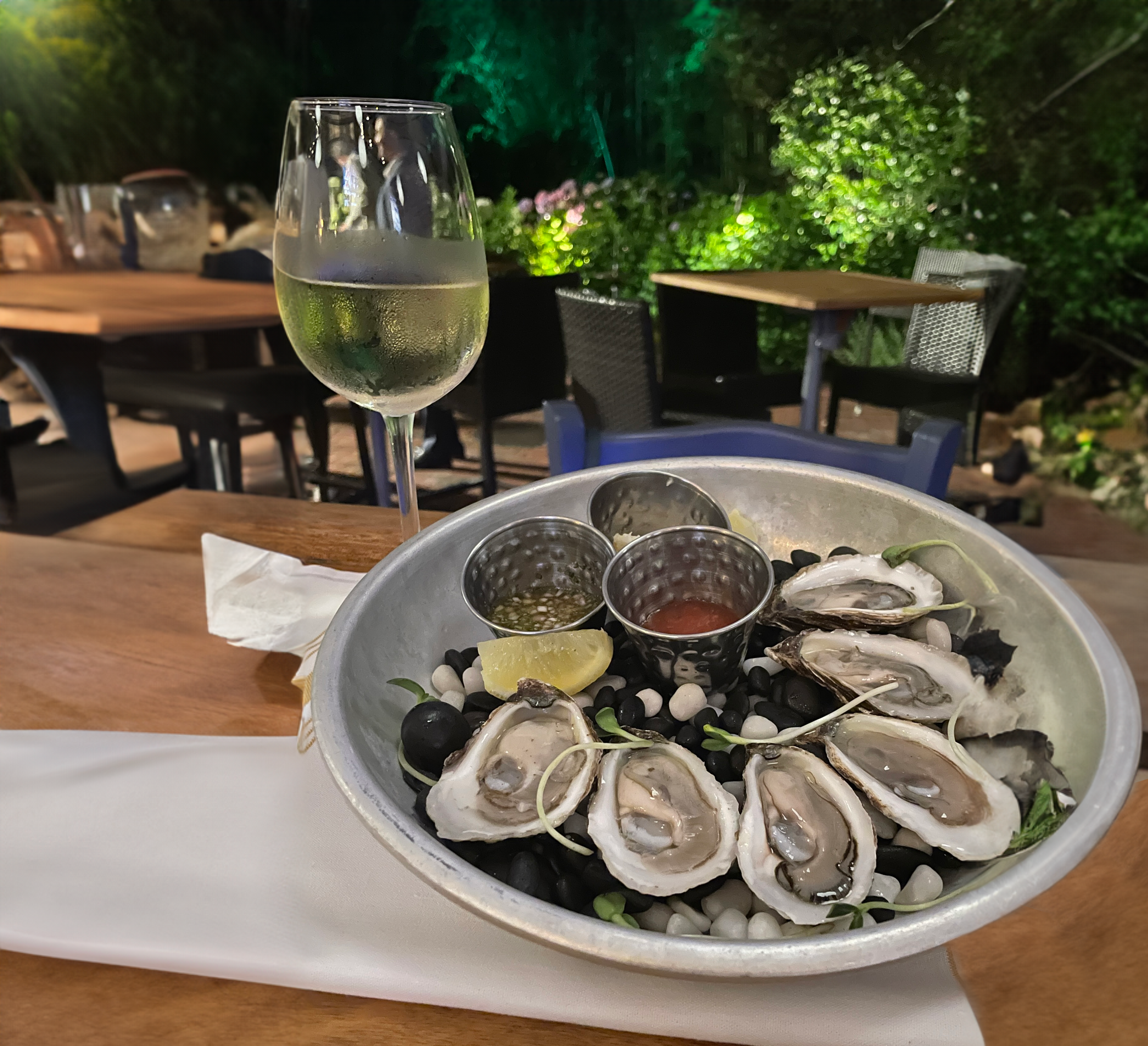 Oysters and wine by the glass re a delicious part of Fauna's Happy Hour